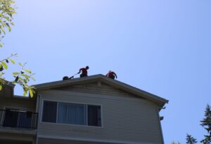 Two workers working on the house roof at Woodinville, WA