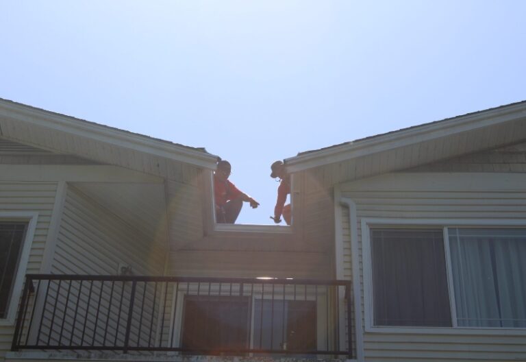 Two workers working on the roof top at Woodinville, WA