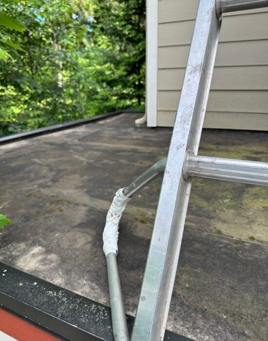 A closeup of a flat roof after it was cleaned by High Point Gutter in Woodinville, WA.