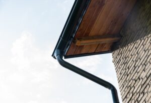 A black gutter and downspout on a home in Seattle, WA