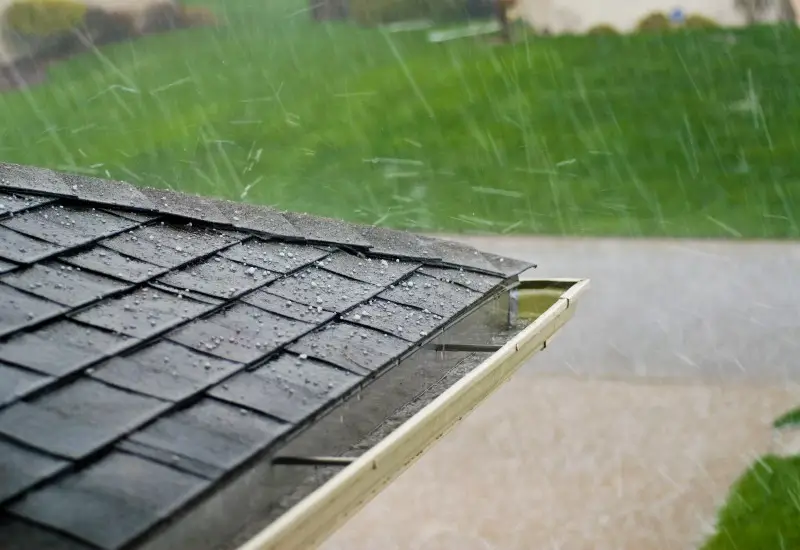 Hail hitting a roof and rain gutters in Renton, Washington