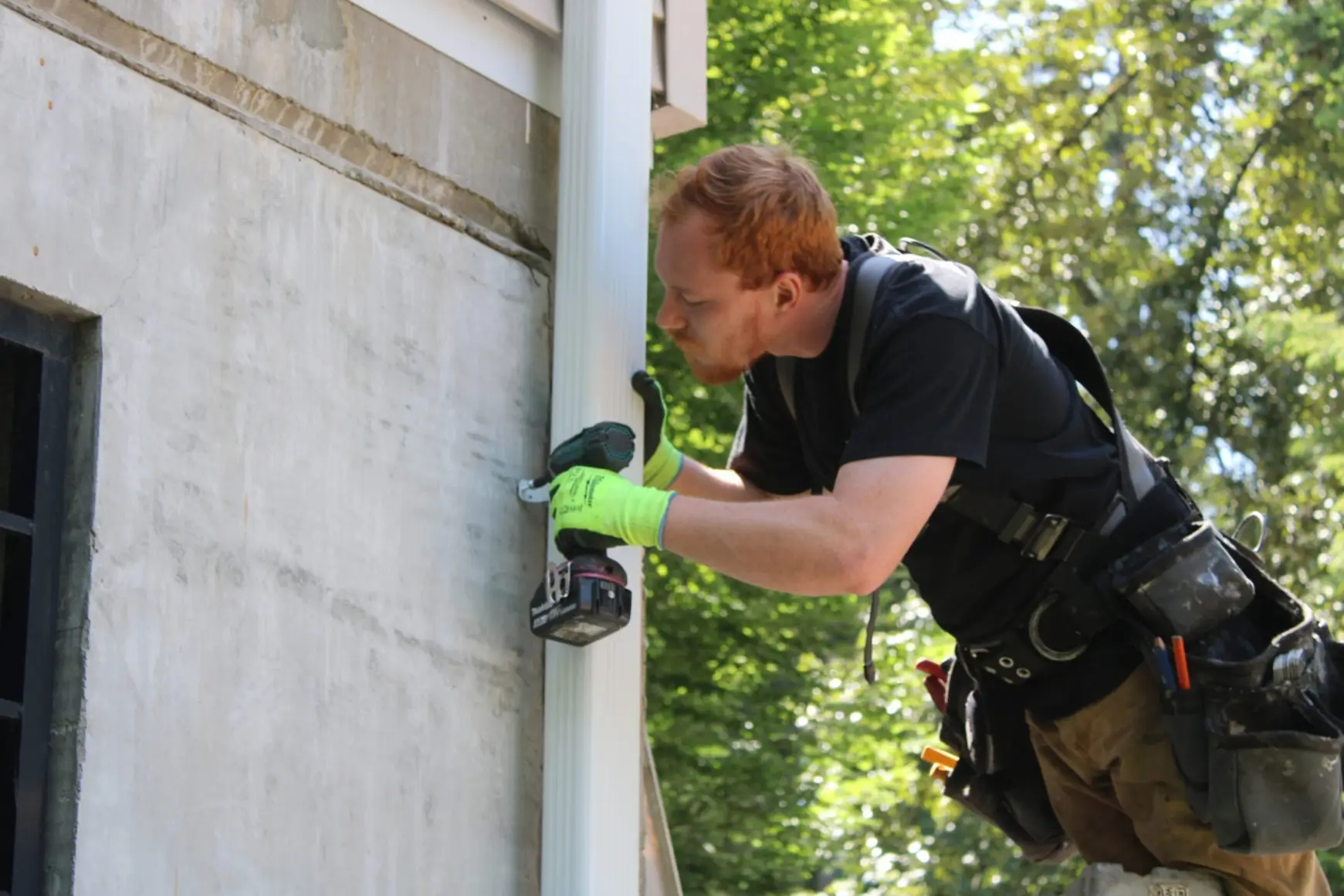 High Point Gutter specialist repairing a downspout in the Greater Seattle area