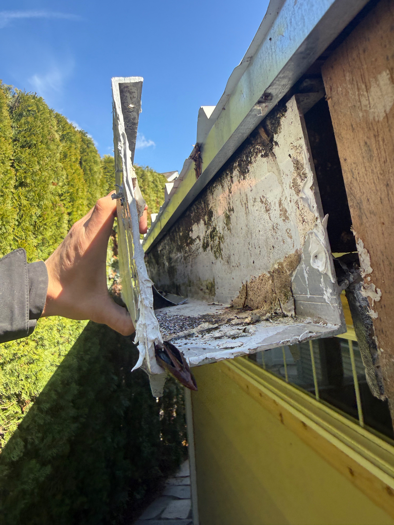 Storm-damaged gutter pulled away from a home