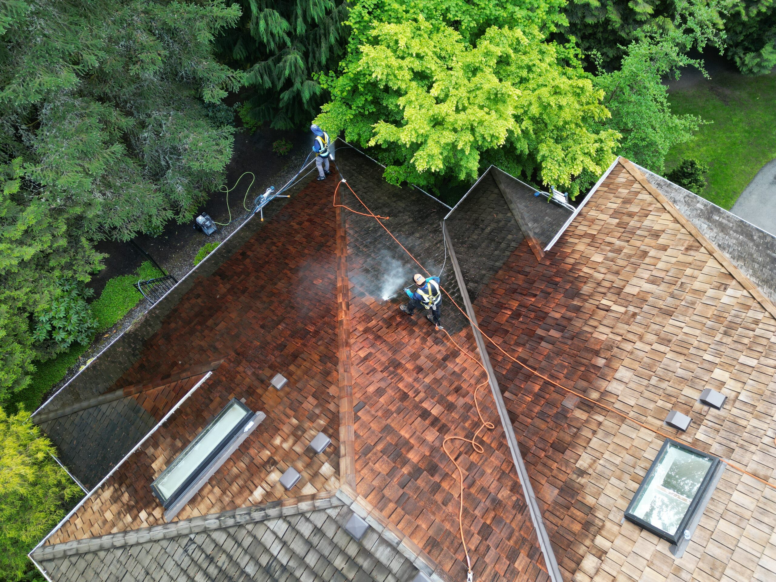 High Point Gutter technician applying a softwash