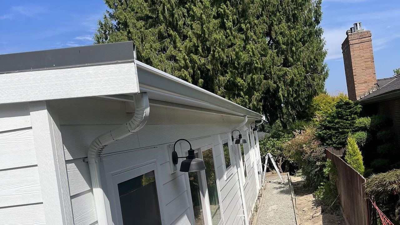 New white seamless gutters and downspout on a home addition in Seattle, WA