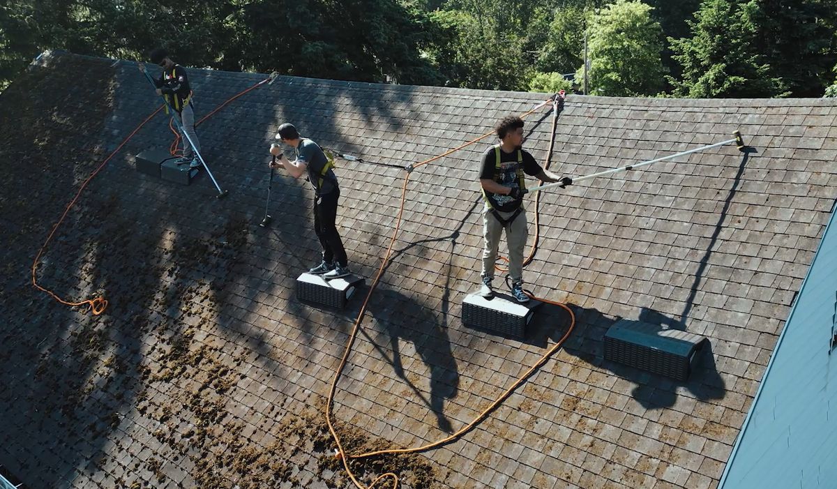 High Point Gutter crew cleaning a roof and gutters