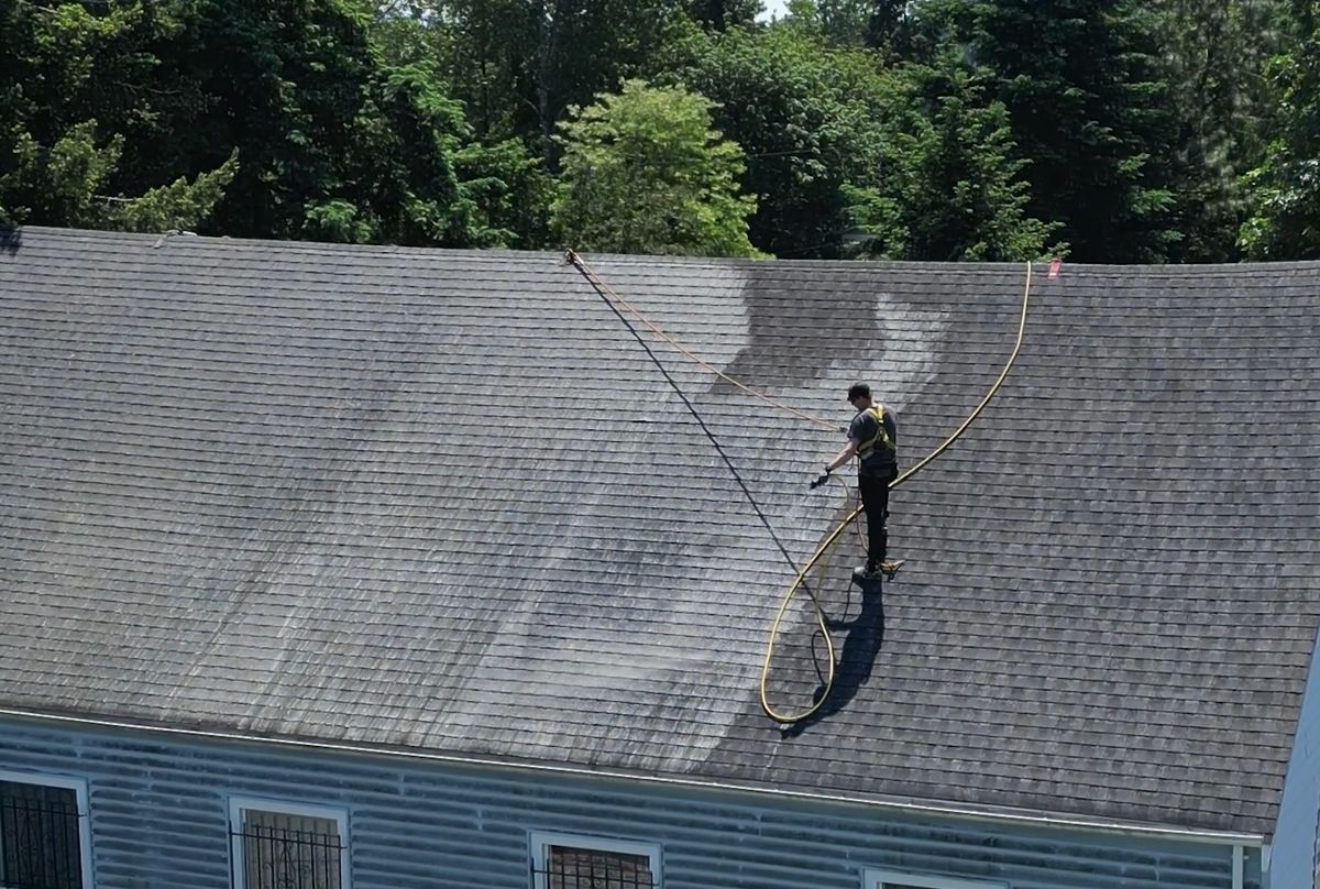 High Point Gutter technician cleaning a roof